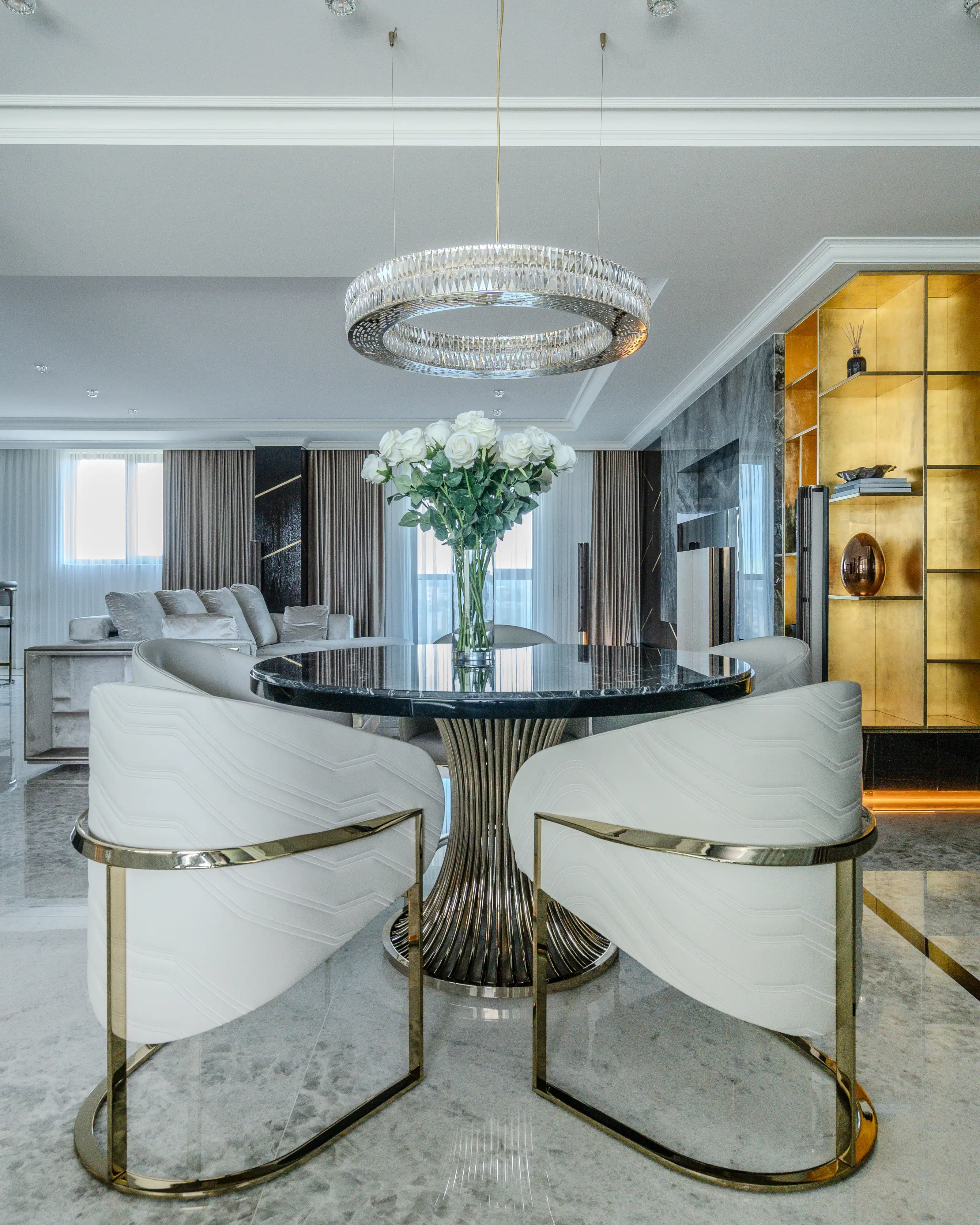 /storage/Luxury brass dining table with flowing sculptural base and round Emperador marble top, inspired by the elegant movement of dancers and crafted for sophisticated interiors.