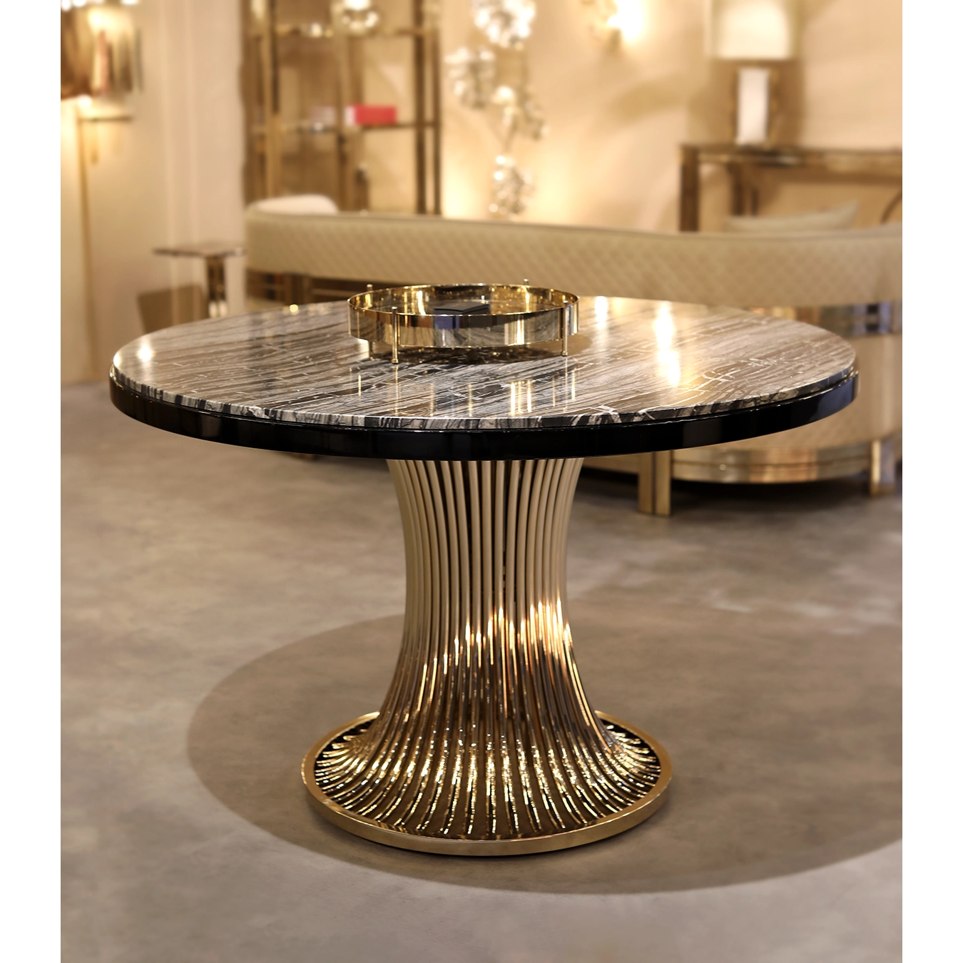/storage/Luxury brass dining table with flowing sculptural base and round Emperador marble top, inspired by the elegant movement of dancers and crafted for sophisticated interiors.