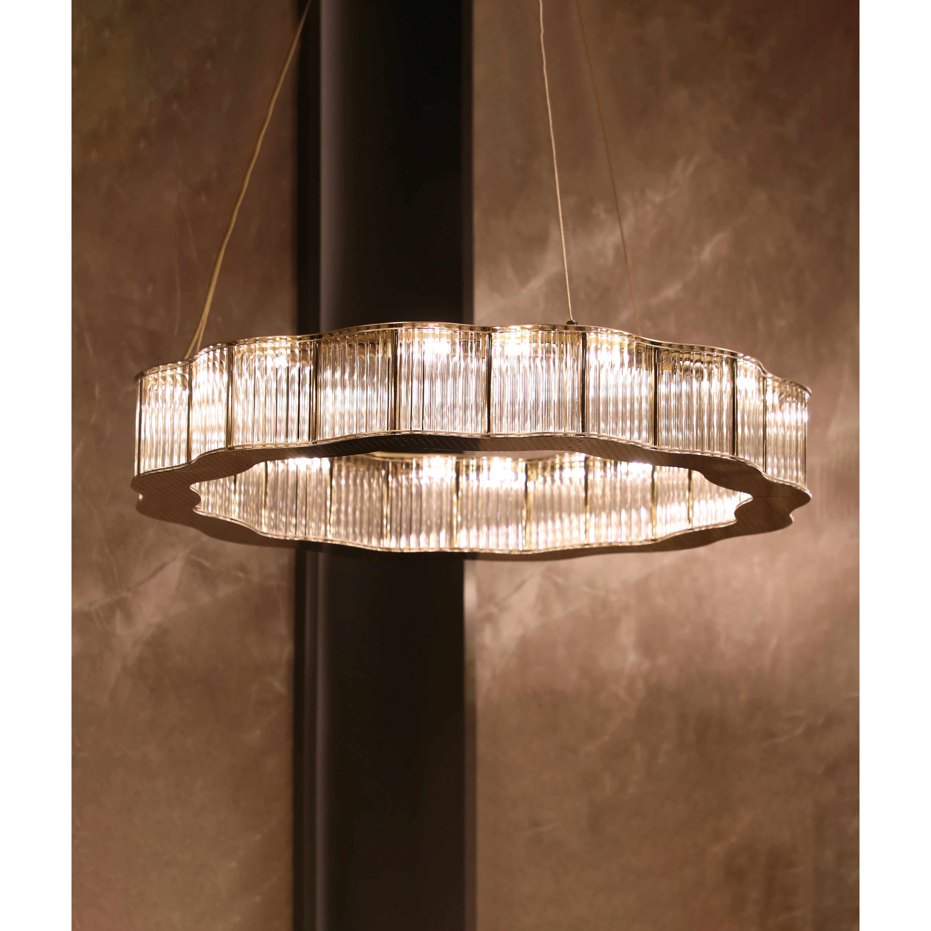 /storage/Luxury brass round suspension with faceted glass and rotating star details, combining Art Deco elegance with modern sophistication.