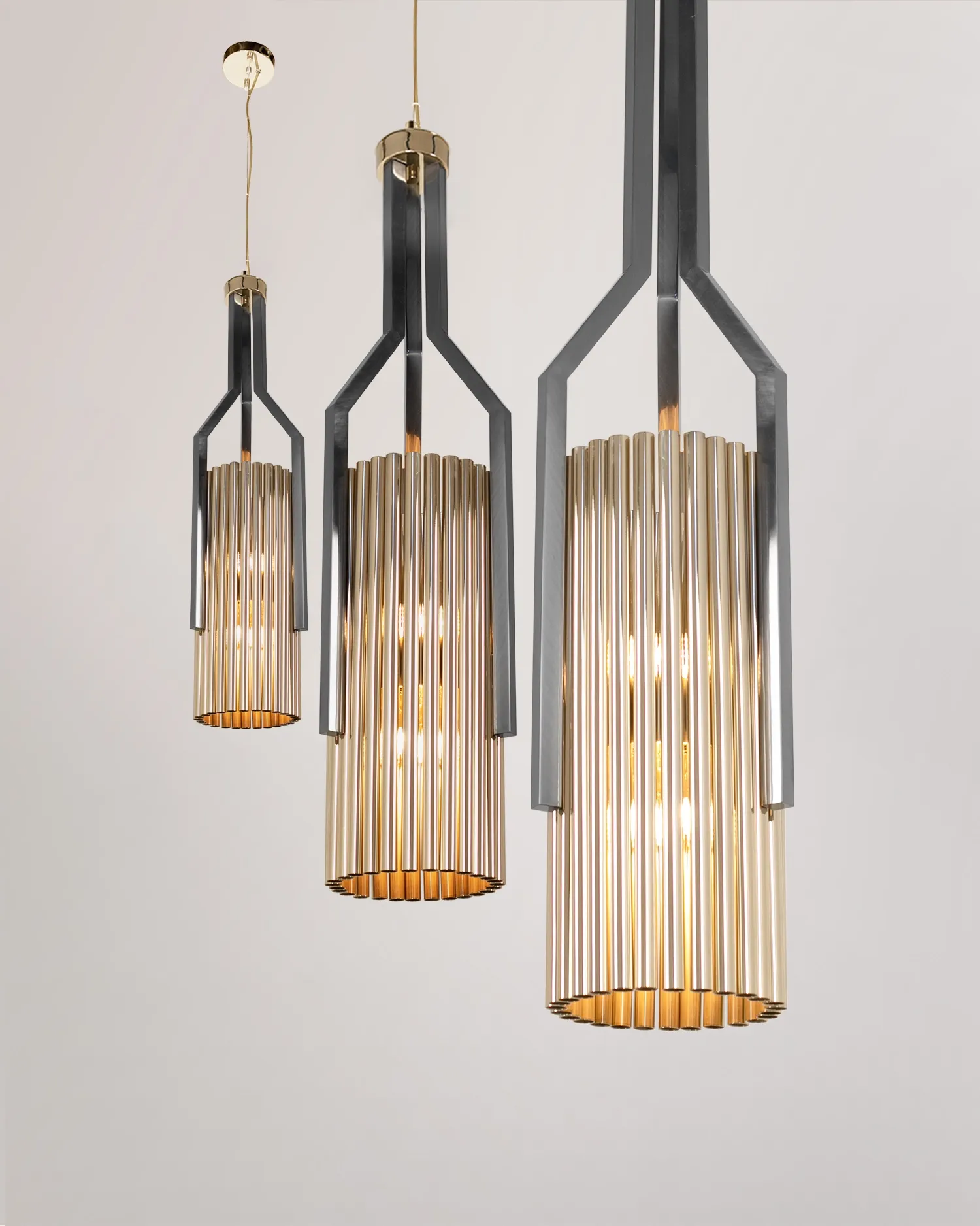 /storage/Luxury brass Avany pendant featuring a striking mix of gold and black nickel tubular shapes, designed as a bold modern lighting statement