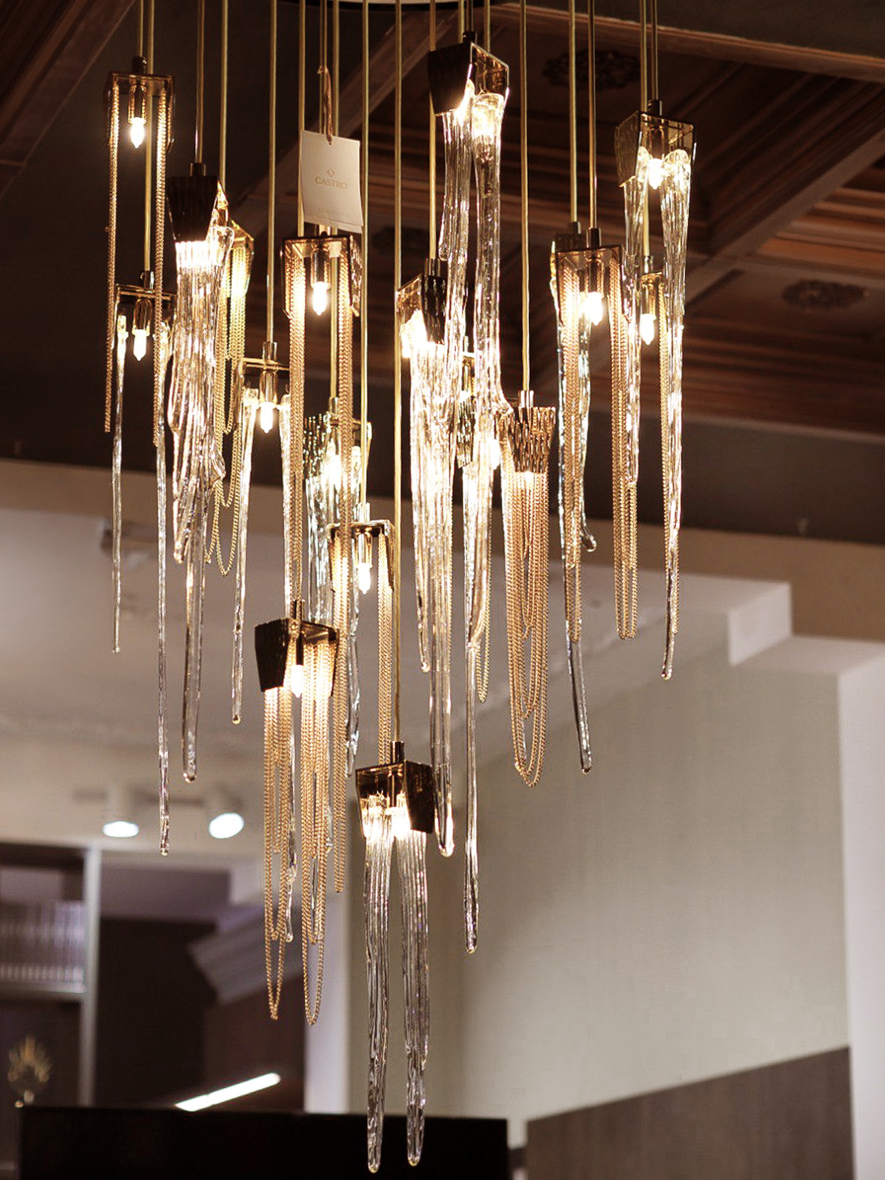 Stala Suspension light fixture in Decoracia showroom Moscow, featuring a minimalist design with polished brass elements.