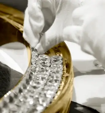 Placement of crystals in a luxury lamp by Castro Lighting, highlighting the precision and sophistication in the assembly process.