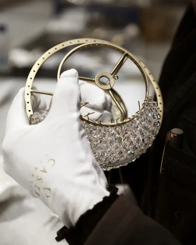 Placement of crystals in a luxury lamp by Castro Lighting, highlighting the precision and sophistication in the assembly process.