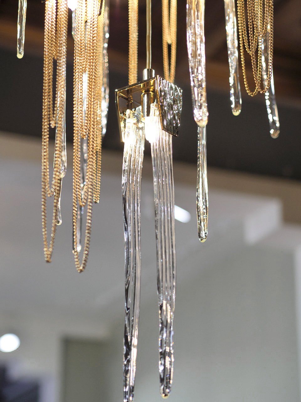 Close-up detail of Stala Suspension light in Decoracia showroom Moscow, focusing on the intricate brass craftsmanship and clean lines.