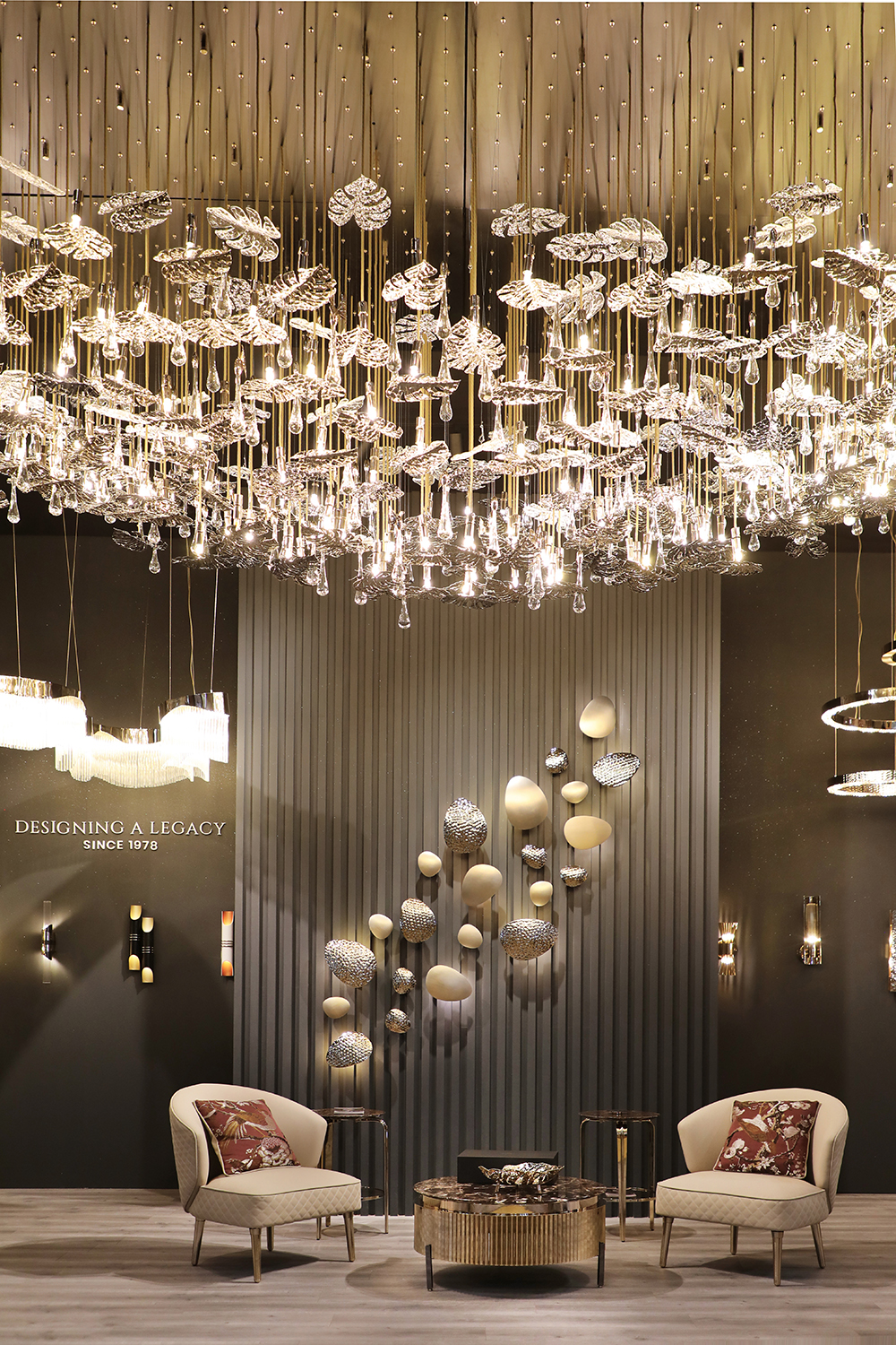 An elegant ambiance with a rainforest-inspired suspension lamp casting a warm glow, paired with the sophisticated design of a Sedere armchair and the refined Tiffany center table.