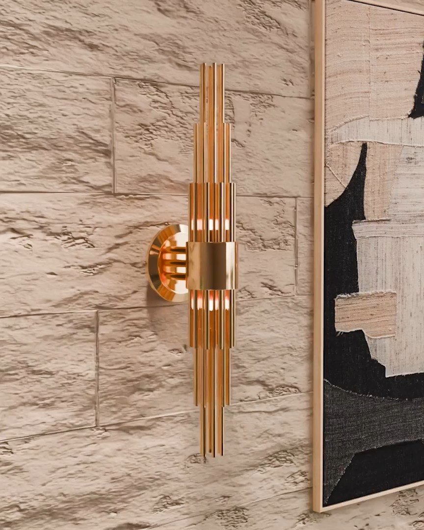 Streamline Wall Light with elongated gold-plated brass tubes casting soft shadows on walls, enhancing texture and depth in a luxury interior during the summer-to-autumn transition.