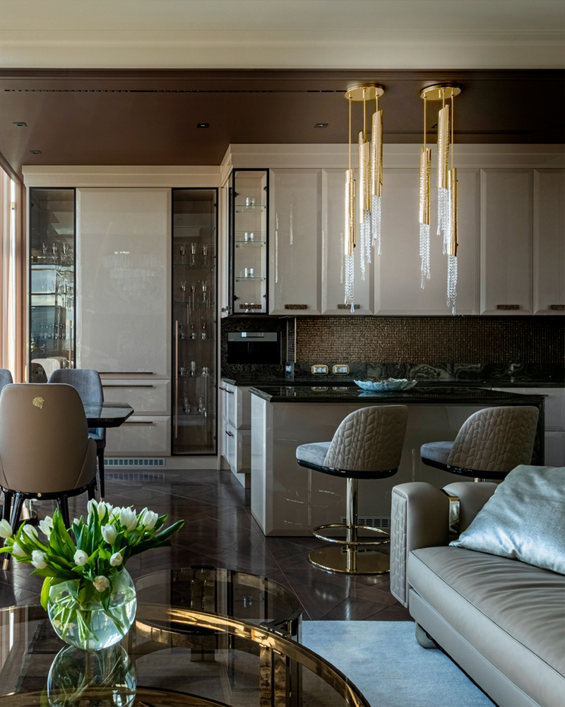 Luxury Avolto suspension fixture combining sculptural hammered brass and shimmering crystal elements