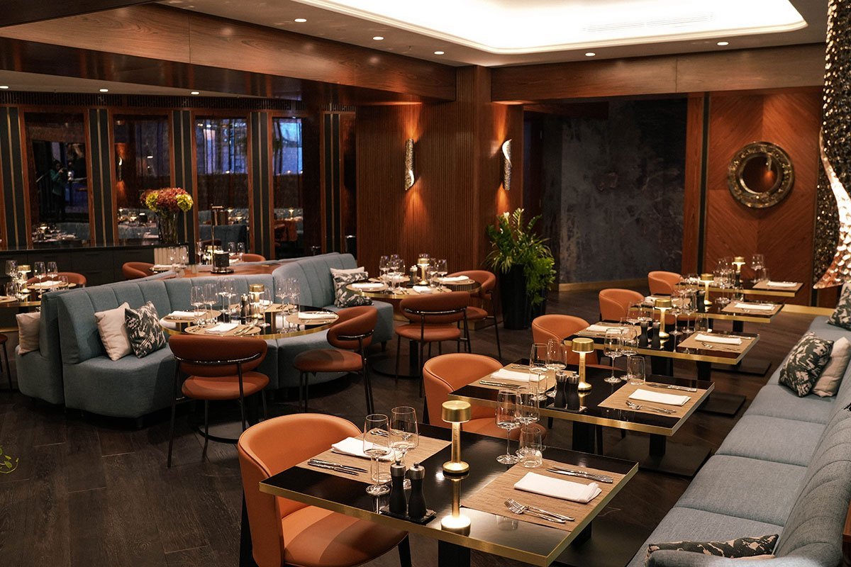 Elven Wall Light and Chantel Table Lamp and Golden Eye Mirror adding warmth and refinement to Ador Restaurant interiors at InterContinental Sofia.