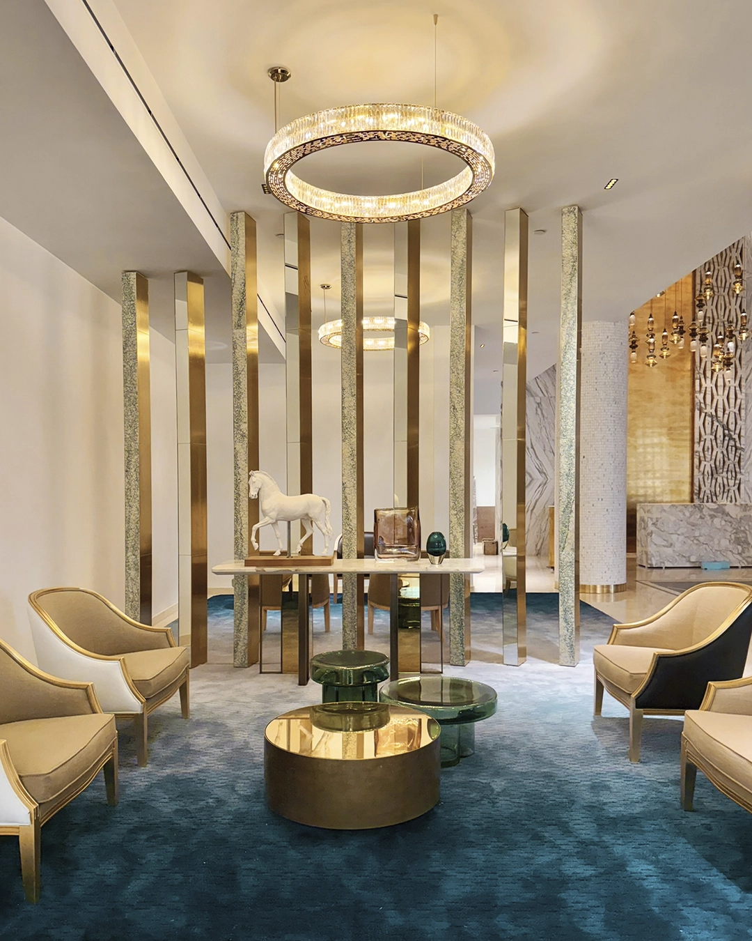 Lobby featuring a Castro chandelier suspension, showcasing lighting collaborations celebrating interior design in 2025.
