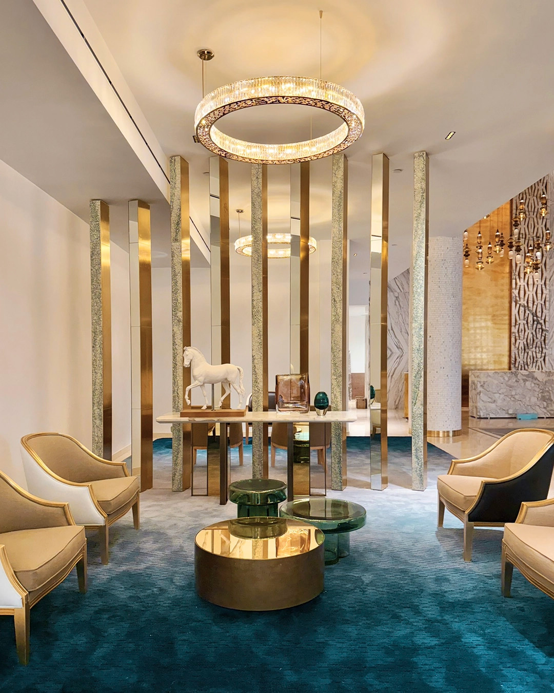 Wellness center lobby featuring a gold-plated Castro suspension light, celebrating interior design collaborations in 2025.
