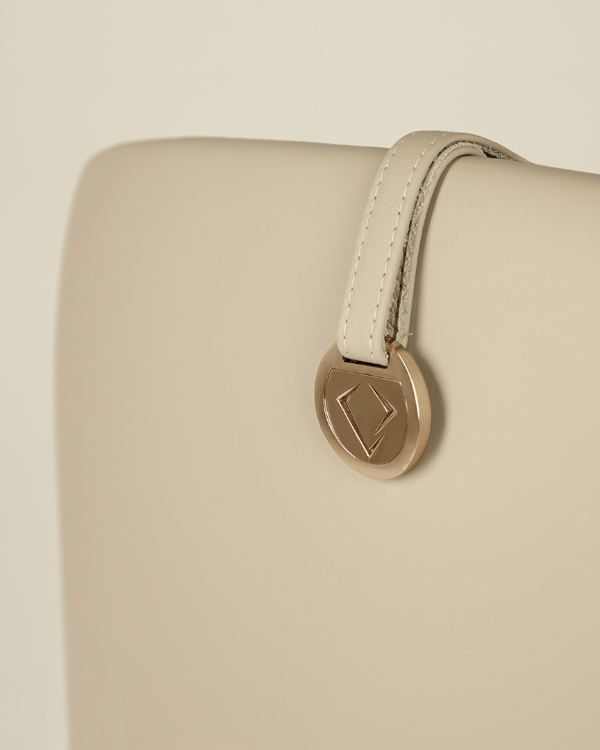 /storage/Luxury brass-accented modern lounge armchair with quilted padded fabric and smooth curves, combining comfort and elegance