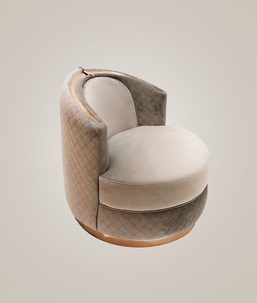 /storage/Luxury brass-accented modern lounge armchair with quilted padded fabric and smooth curves, combining comfort and elegance