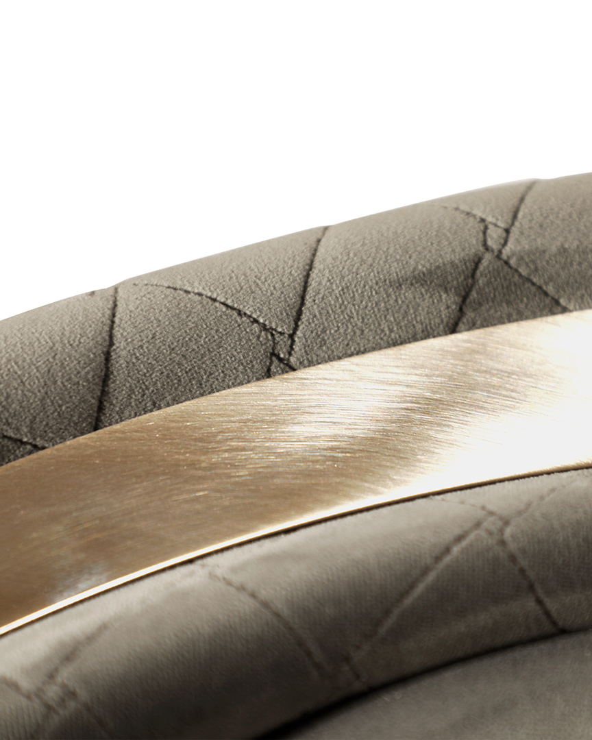 /storage/Luxury brass-accented modern lounge armchair with quilted padded fabric and smooth curves, combining comfort and elegance