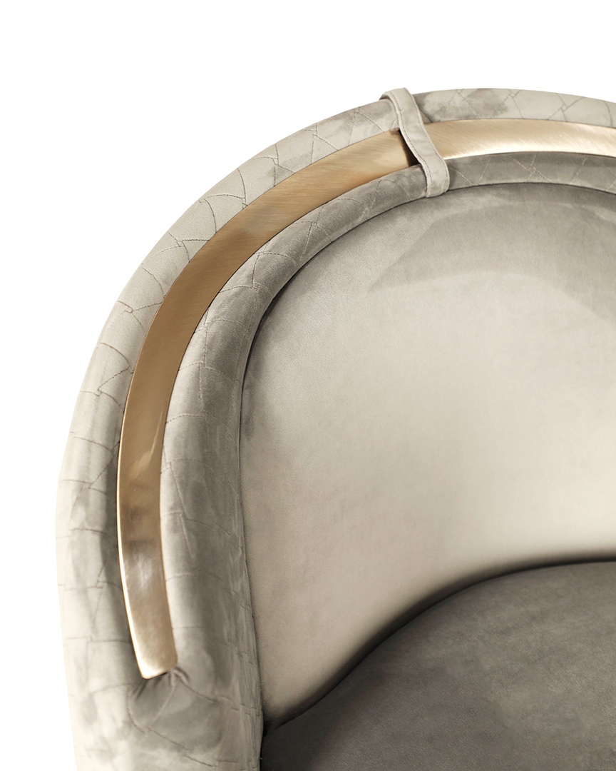 /storage/Luxury brass-accented modern lounge armchair with quilted padded fabric and smooth curves, combining comfort and elegance