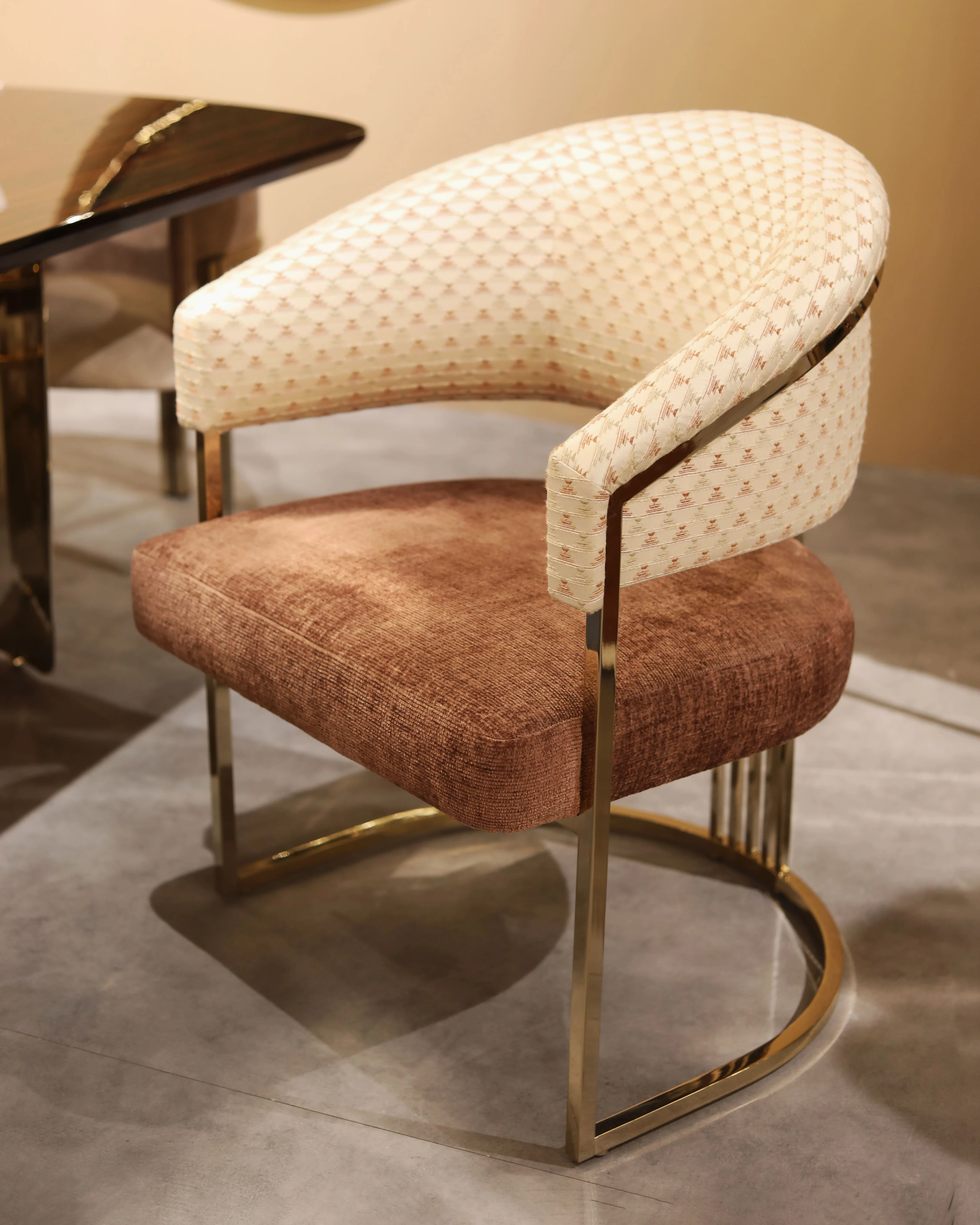/storage/Luxury brass armchair with elegant harp-shaped design by Castro Interiors.