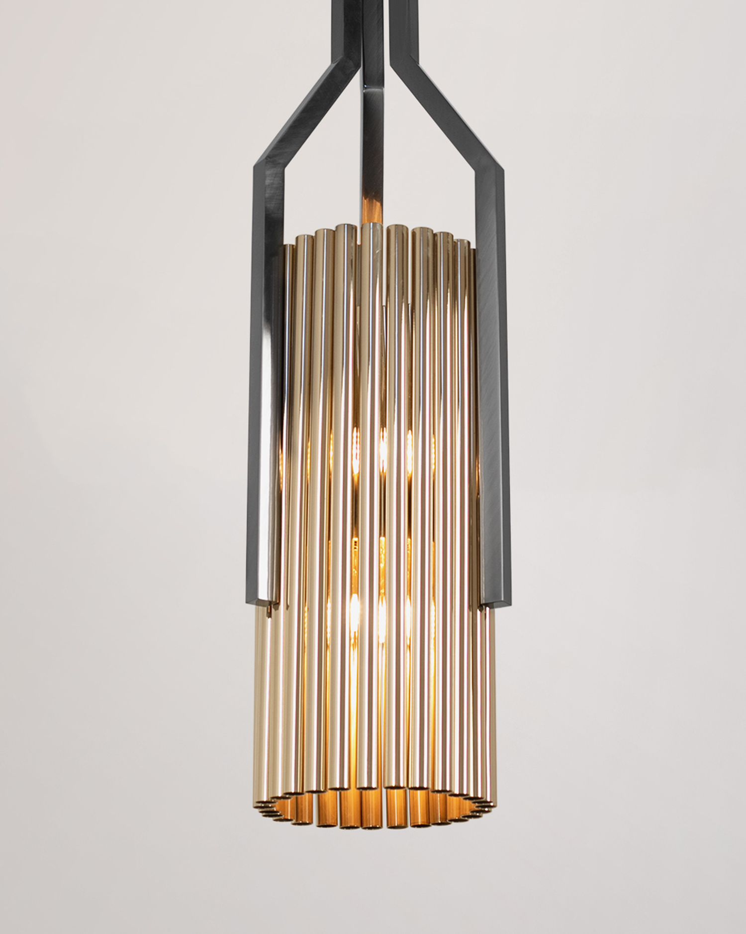 /storage/Luxury brass Avany pendant featuring a striking mix of gold and black nickel tubular shapes, designed as a bold modern lighting statement