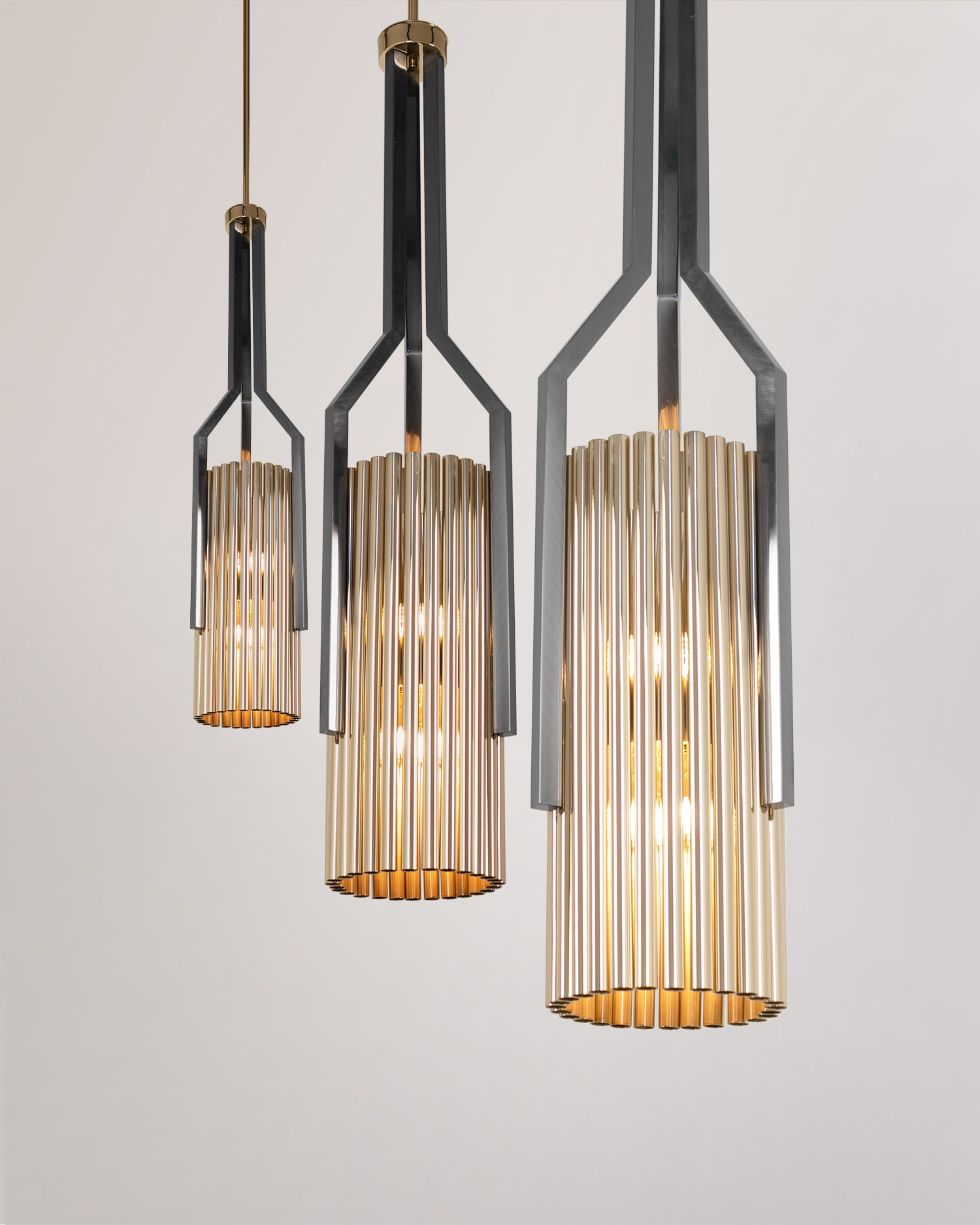 /storage/Luxury brass Avany pendant featuring a striking mix of gold and black nickel tubular shapes, designed as a bold modern lighting statement