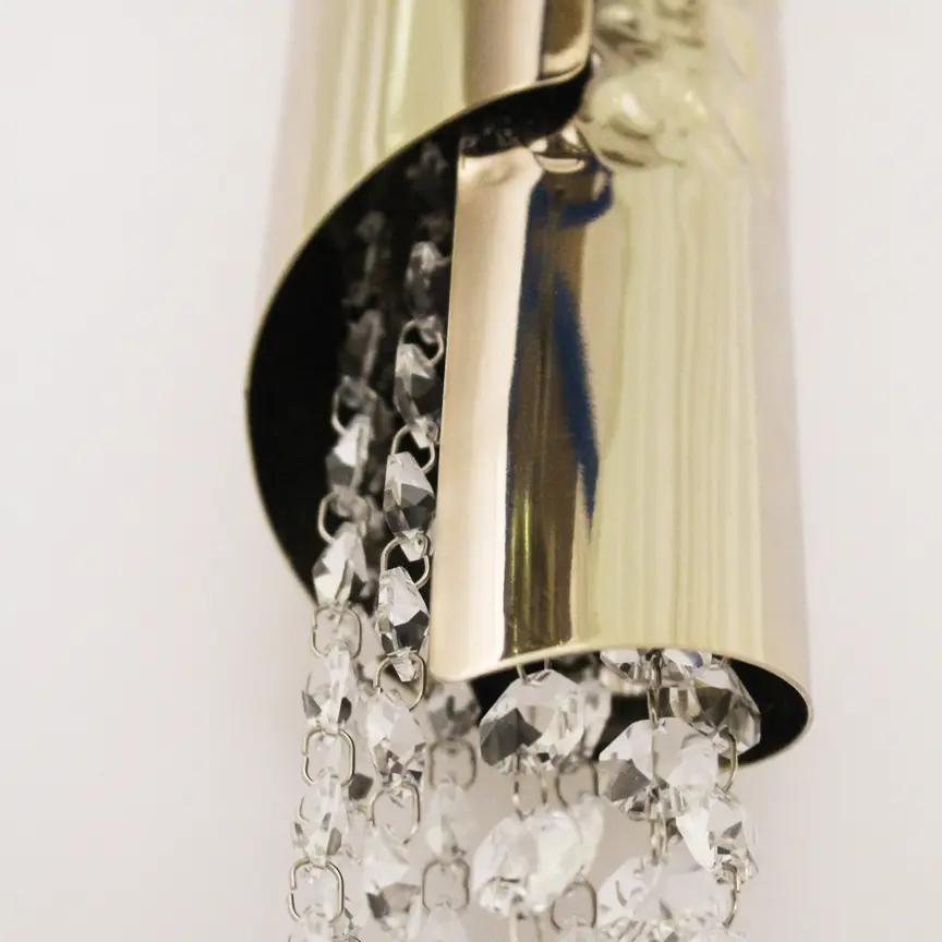 /storage/Luxury brass Avolto Wall Light with hammered gold-plated tubes and crystal details, a sophisticated contemporary fixture for refined interiors.