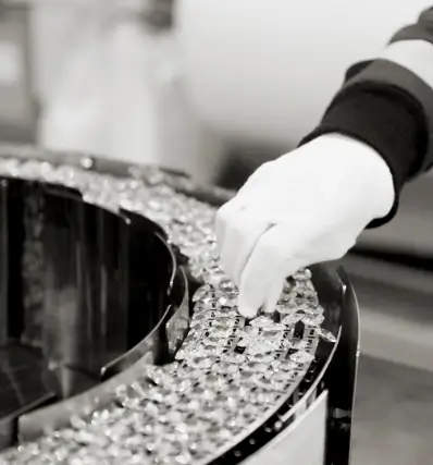 Placement of crystals in a luxury lamp by Castro Lighting, highlighting the precision and sophistication in the assembly process.