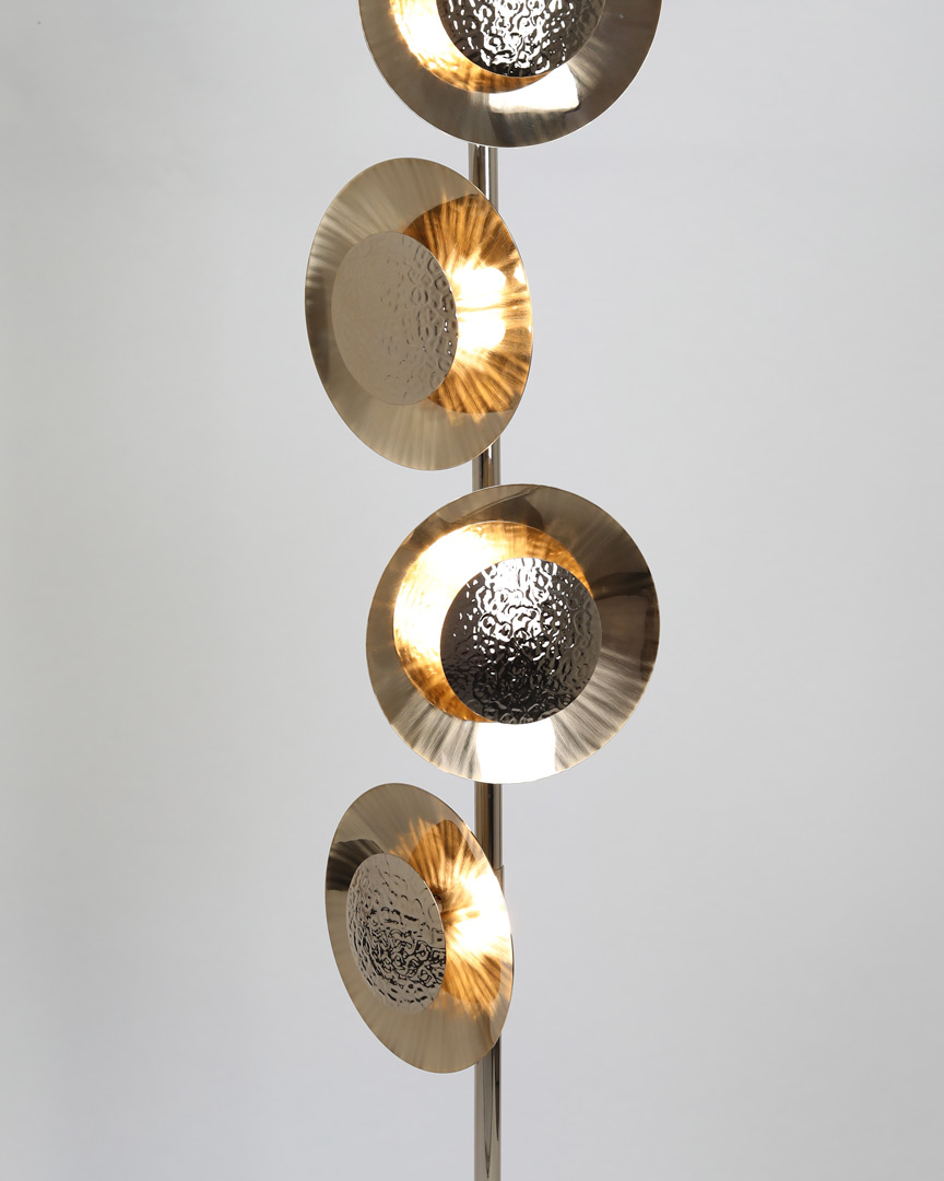 /storage/Luxury brass Eclipse floor lamp with hand-hammered rounded brass plates and gold-plated finish, radiating a warm modern glow.