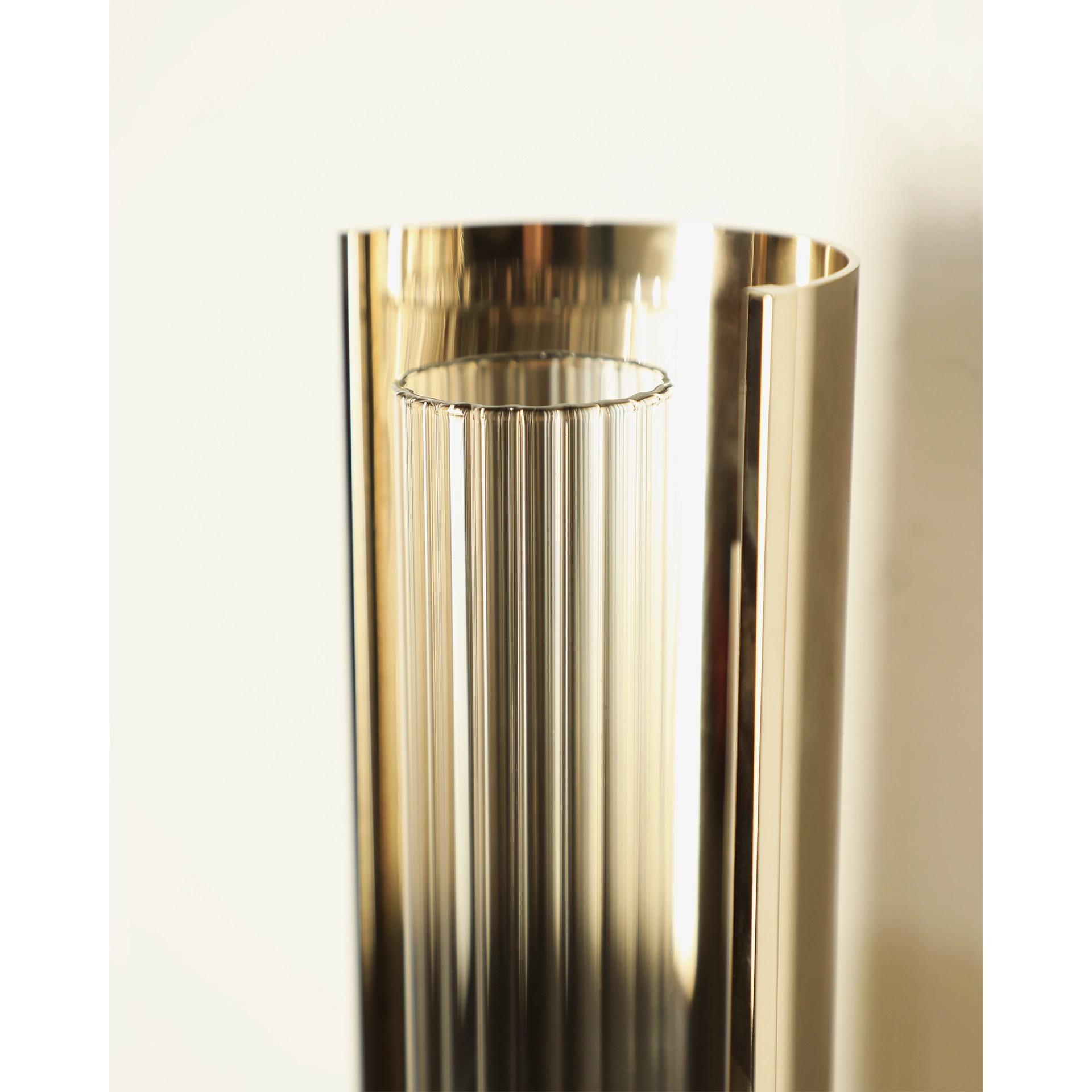 /storage/Luxury brass Baccara Wall Light with corrugated glass and refined futuristic design.
