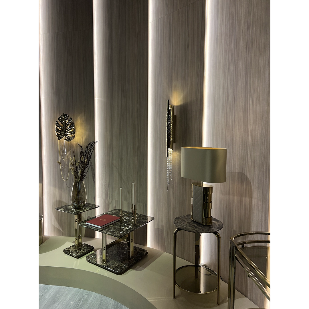 /storage/Luxury brass and marble center table with geometric columns, blending modern elegance and bold design for a refined, opulent living space.