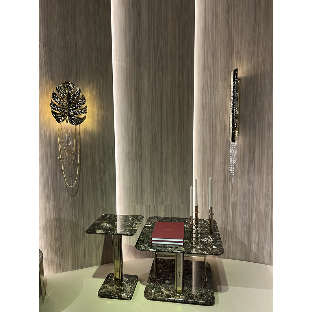 /storage/Luxury brass and marble center table with geometric columns, blending modern elegance and bold design for a refined, opulent living space.
