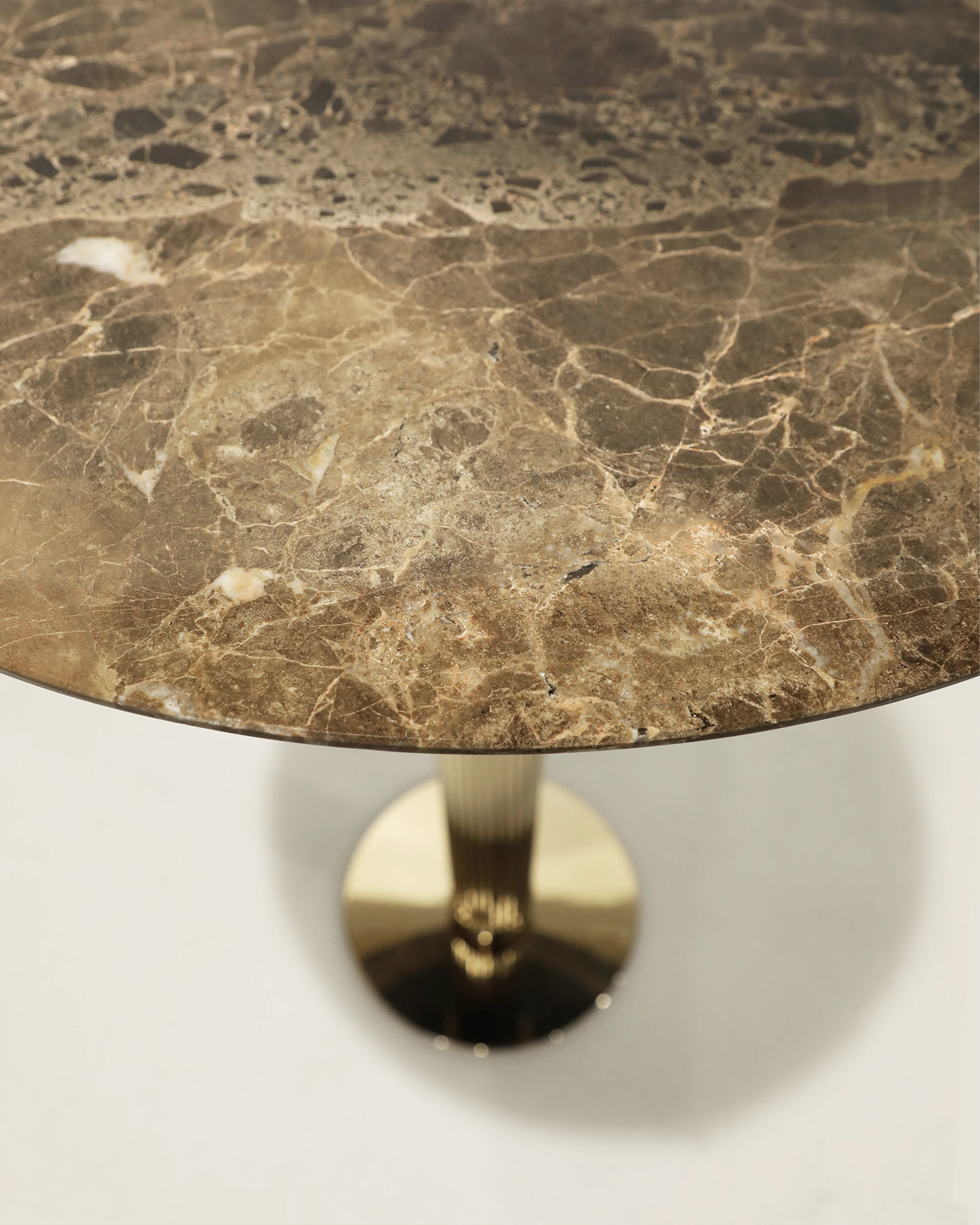 /storage/Luxury brass Eléa Bar Table with Corinthian column-inspired gold-plated brass base and Emperador marble top, blending classical Greek elegance with modern sophistication for refined dining and bar interiors.