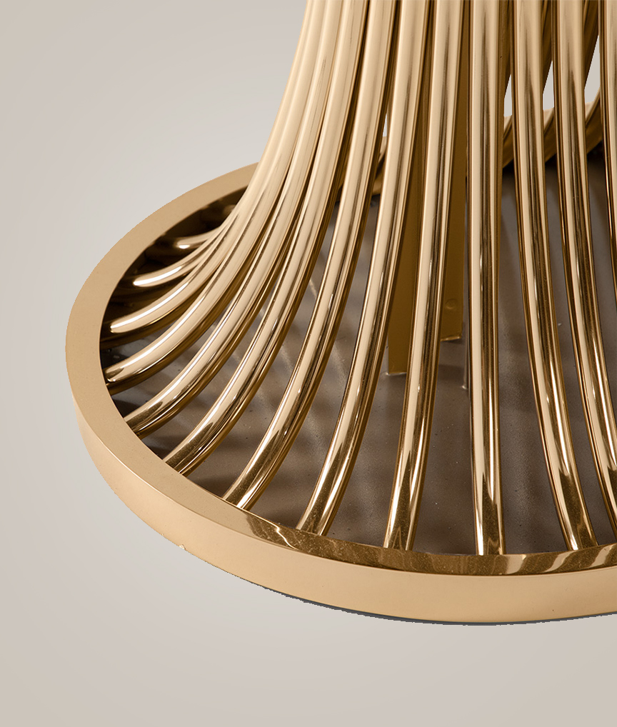 /storage/Luxury brass and Emperador marble dining table with flowing curved tube base, a sculptural modern design for elegant interiors.