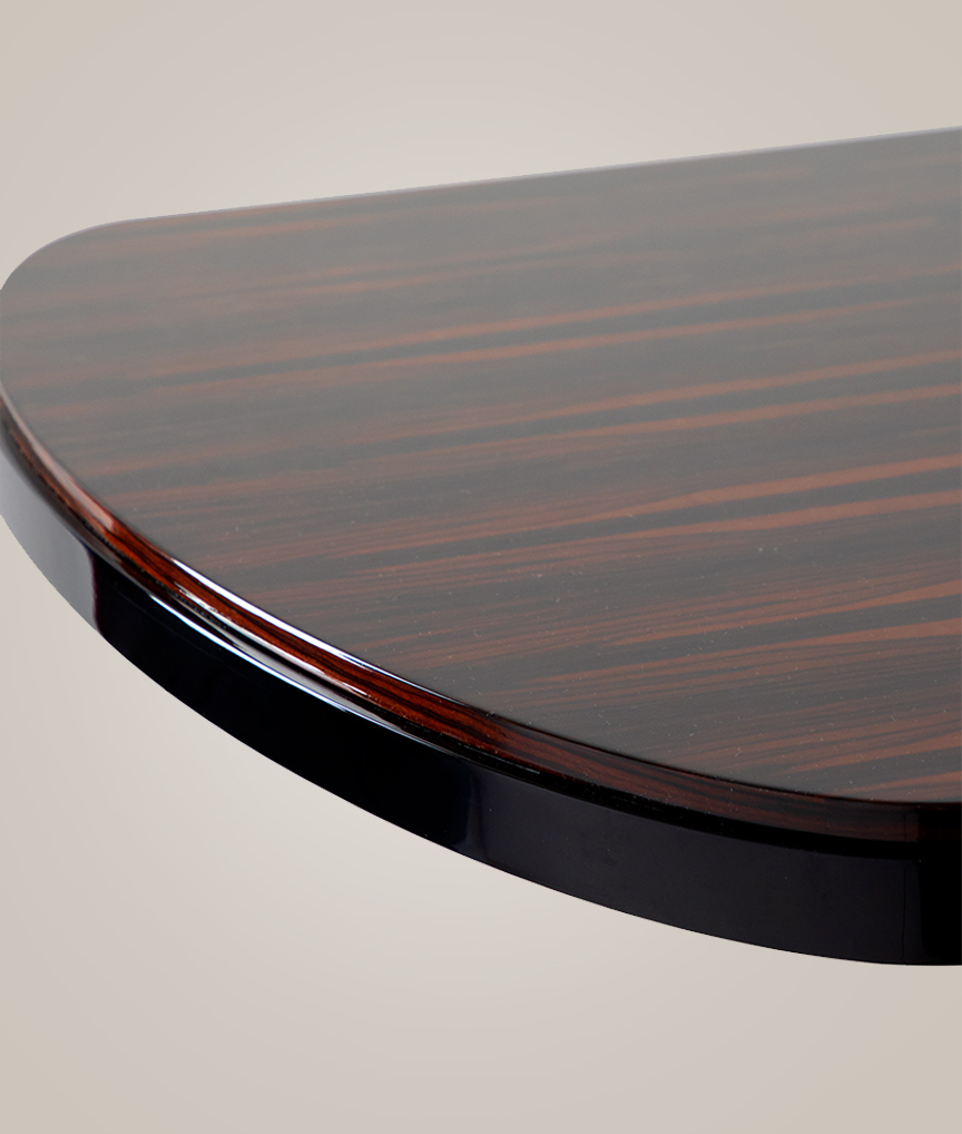 /storage/Luxury brass and Emperador marble dining table with flowing curved tube base, a sculptural modern design for elegant interiors.