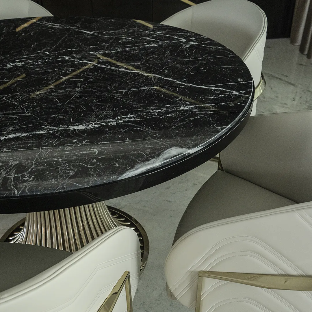 /storage/Luxury brass dining table with flowing sculptural base and round Emperador marble top, inspired by the elegant movement of dancers and crafted for sophisticated interiors.