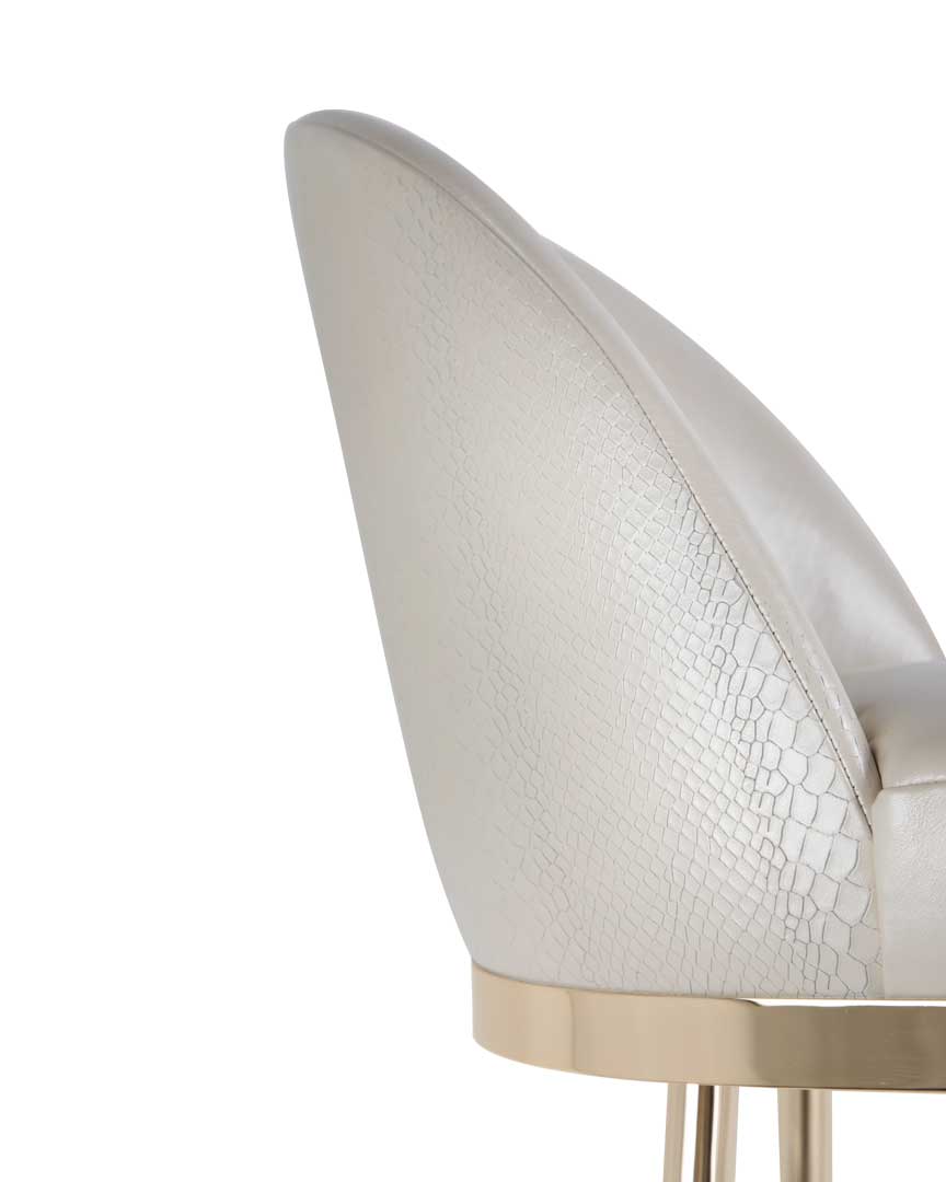 /storage/Luxury brass bar chair with gold-plated legs, black nickel accents, and curved upholstered body, blending Art Deco style with modern femininity.