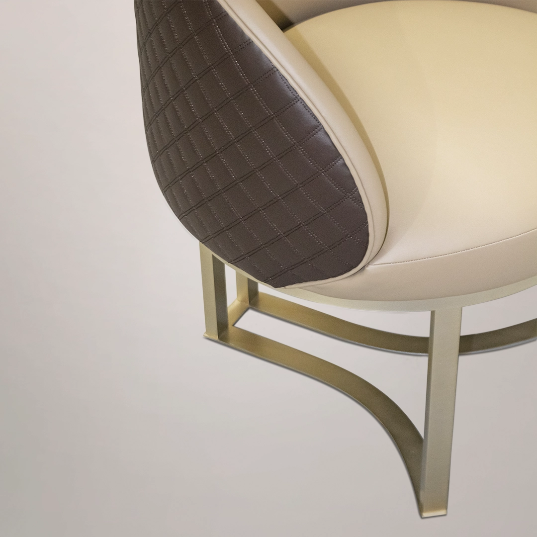 /storage/Luxury brass chair with beige leather upholstery and twisted brass detailing, blending feminine charm with refined contemporary design.