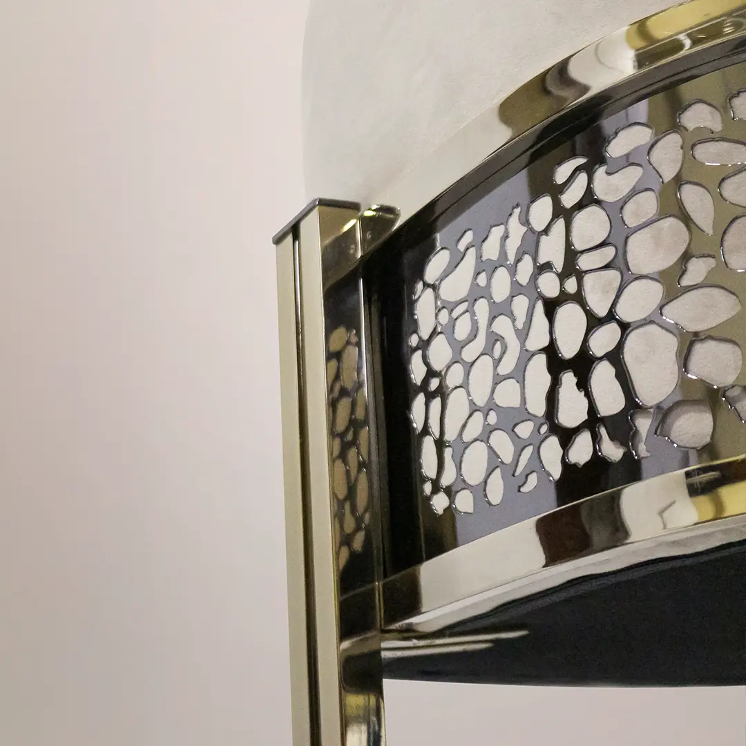 /storage/Luxury brass bar chair with beige upholstery and hand-sculpted giraffe print backrest, blending regal elegance with safari-inspired design.