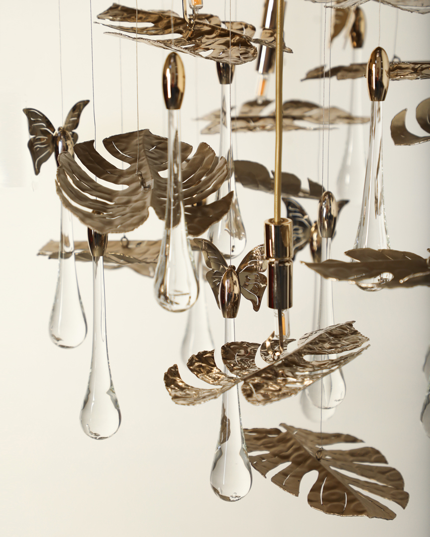 /storage/Luxury brass suspension with nature-inspired raindrop and butterfly details by Castro Lighting.
