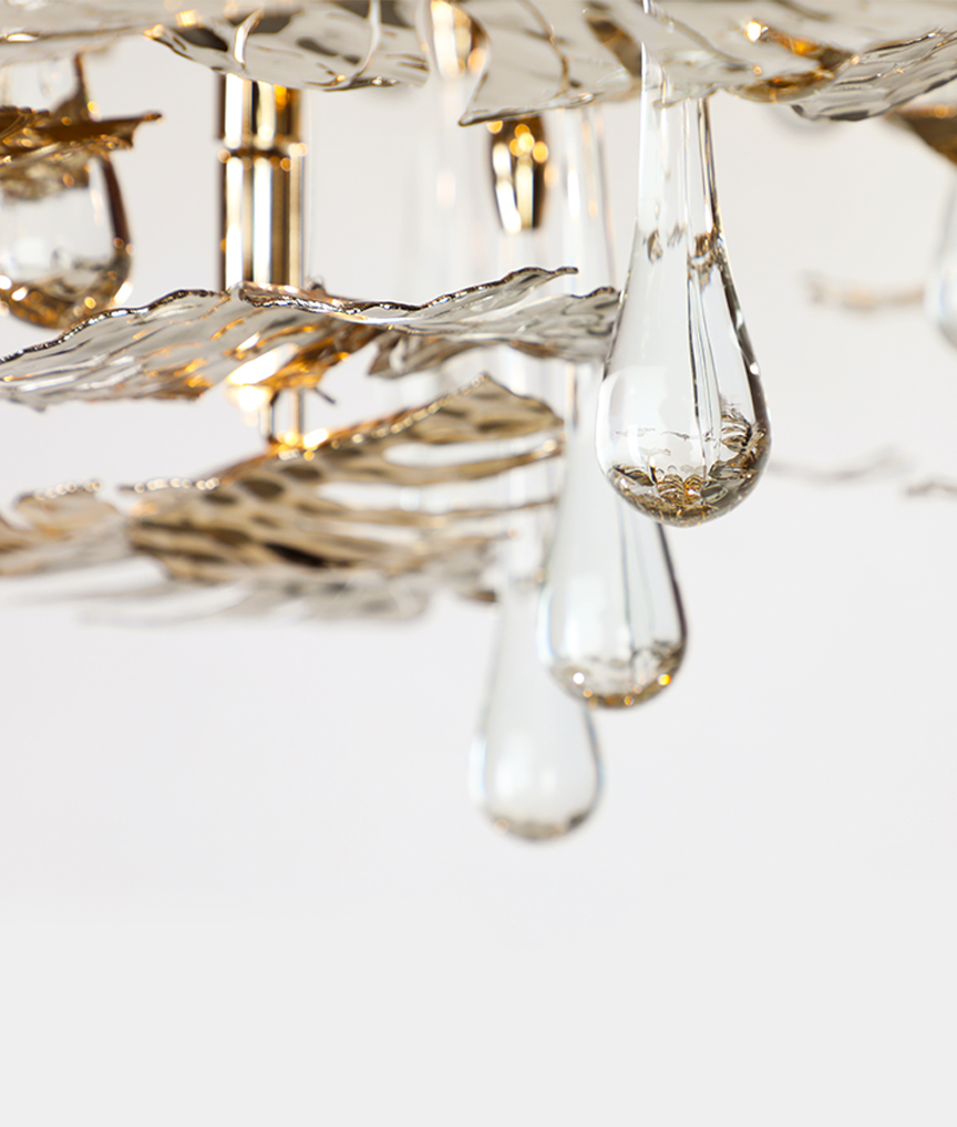 /storage/Luxury brass suspension with nature-inspired raindrop and butterfly details by Castro Lighting.