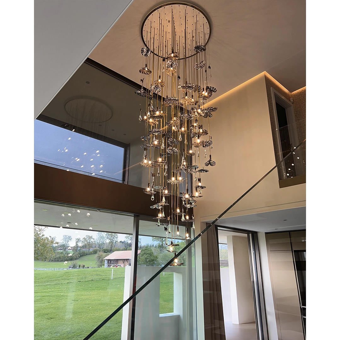 /storage/Luxury brass suspension with nature-inspired raindrop and butterfly details by Castro Lighting.