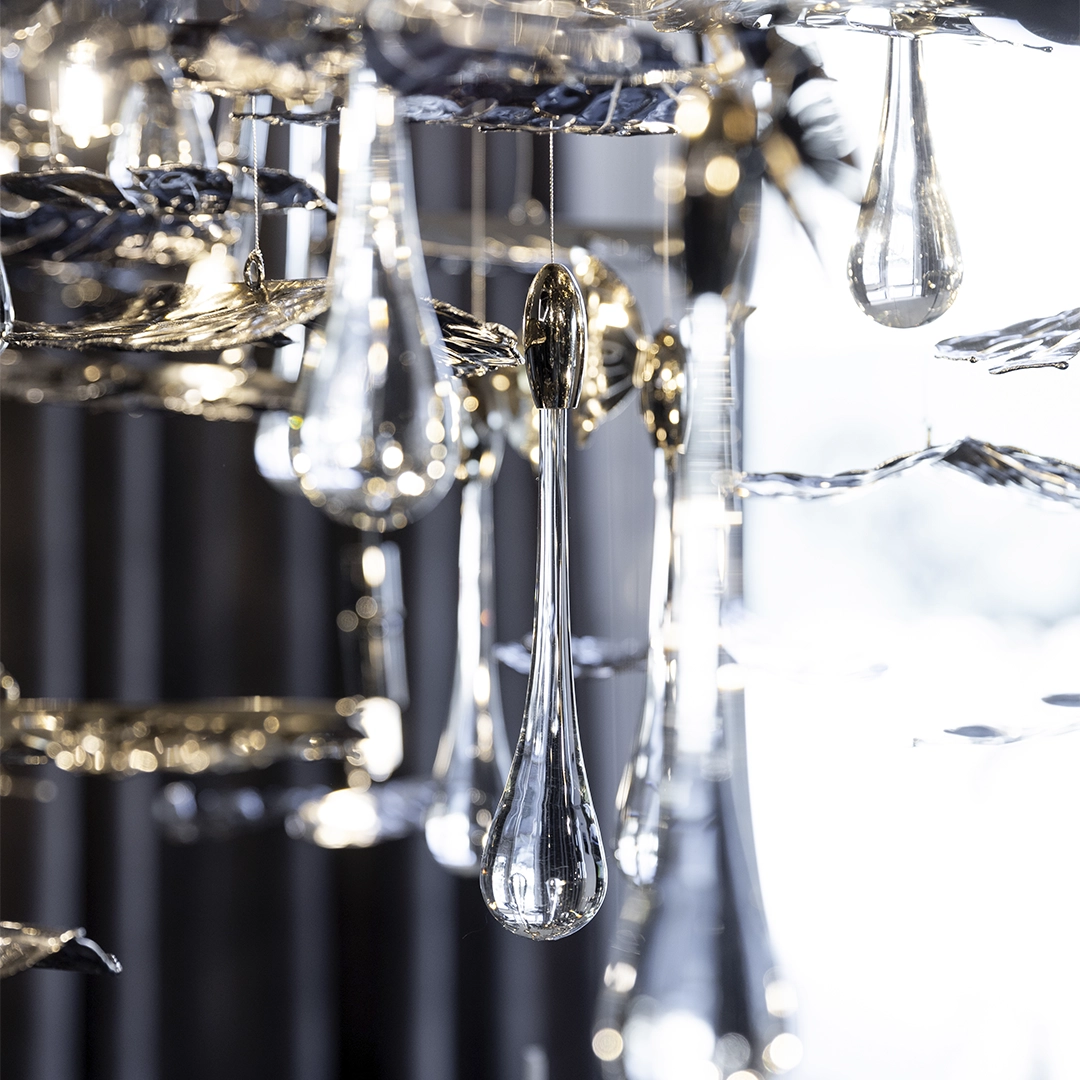 /storage/Luxury brass suspension with nature-inspired raindrop and butterfly details by Castro Lighting.