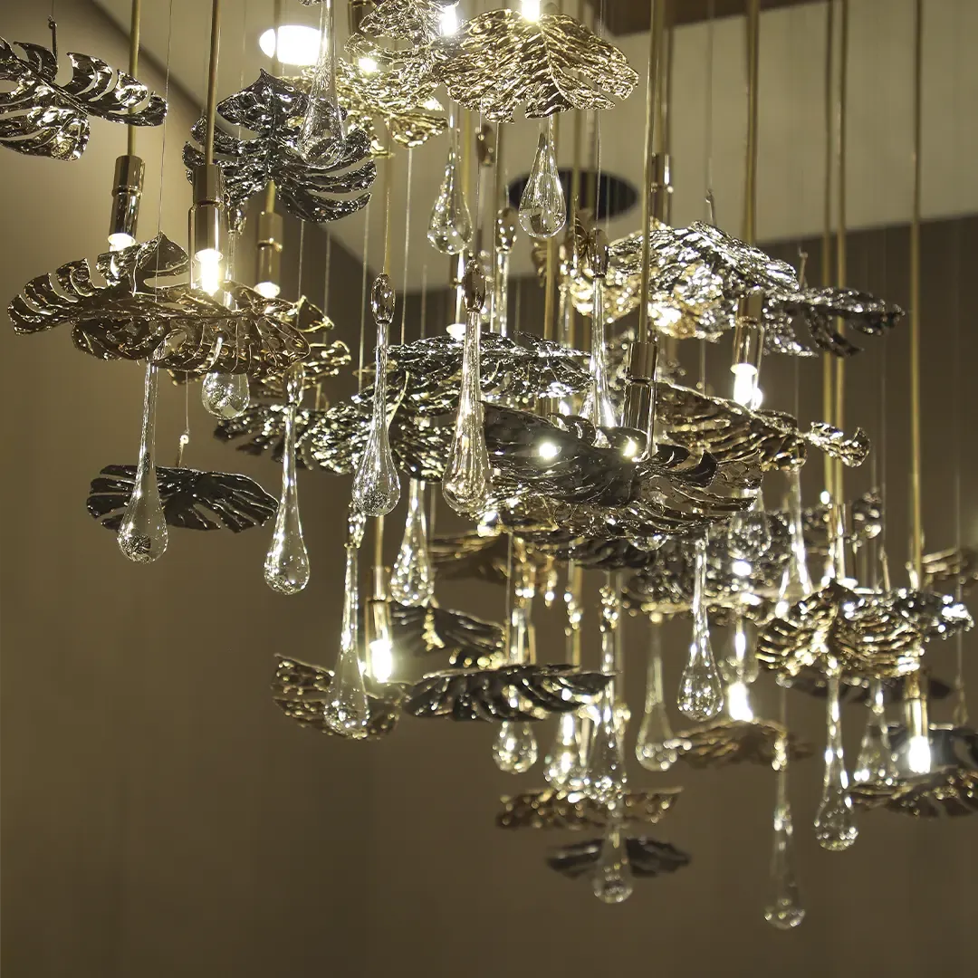 /storage/Luxury brass suspension with nature-inspired raindrop and butterfly details by Castro Lighting.