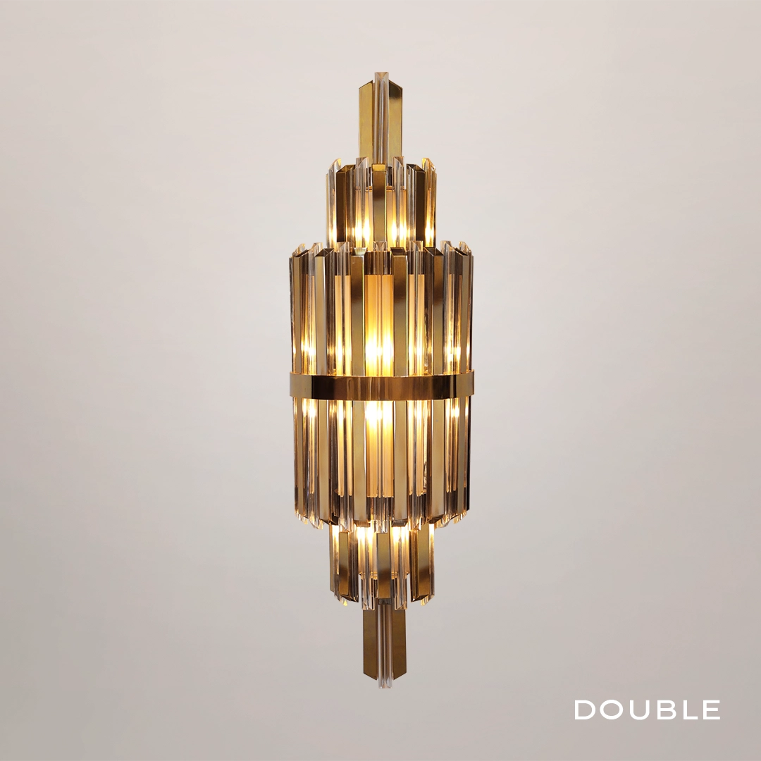 /storage/Luxury brass Skylar Wall Light with gold-plated brass and glass in a cosmic-inspired design.
