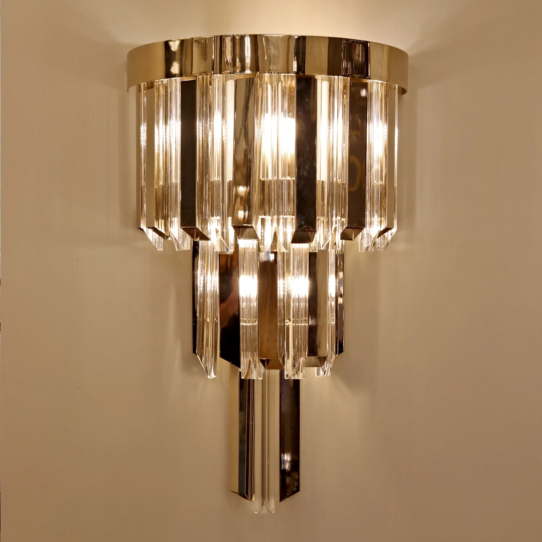/storage/Luxury brass Skylar Wall Light with gold-plated brass and glass in a cosmic-inspired design.