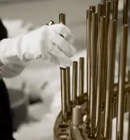 Craftsman manually assembling a luxury lamp from Castro Lighting, highlighting the handcrafted process and attention to detail.