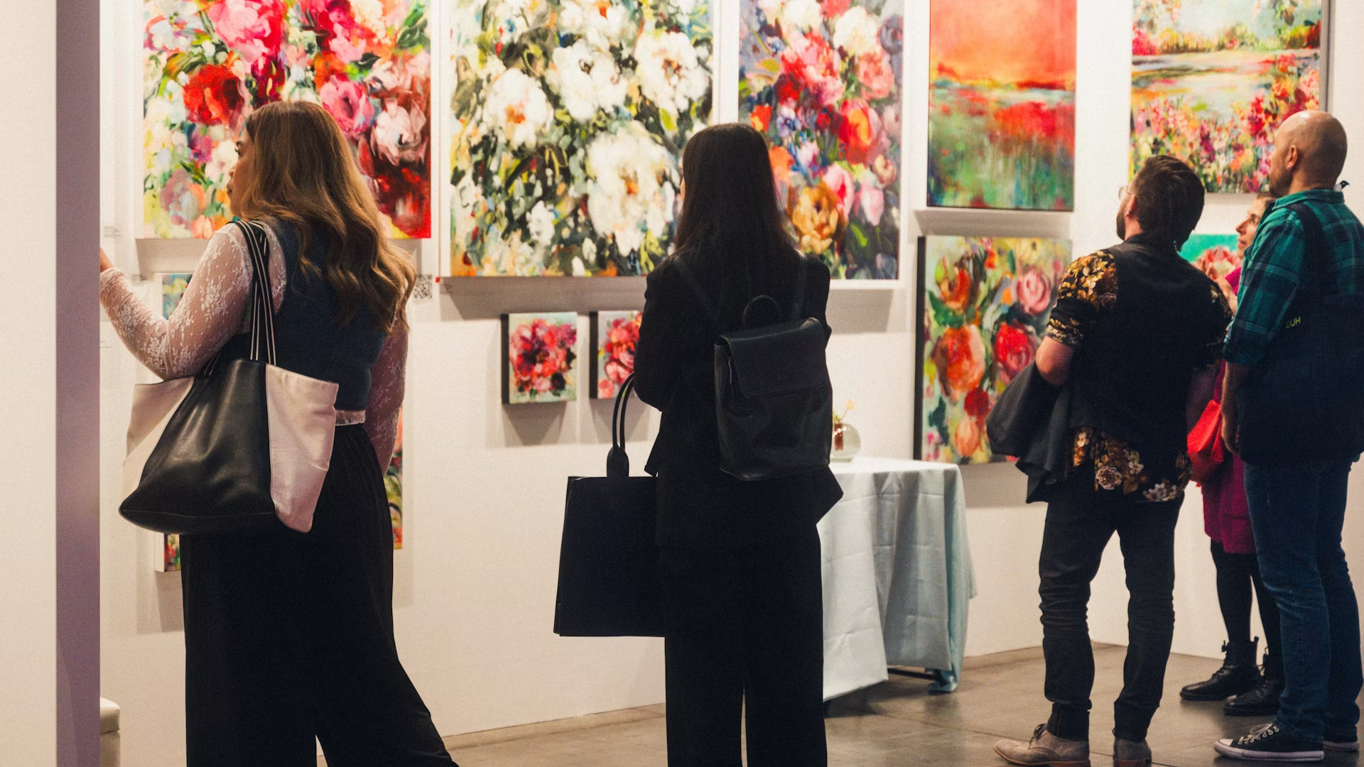 IDS Vancouver visitors viewing a colourful floral art exhibition and contemporary design display.